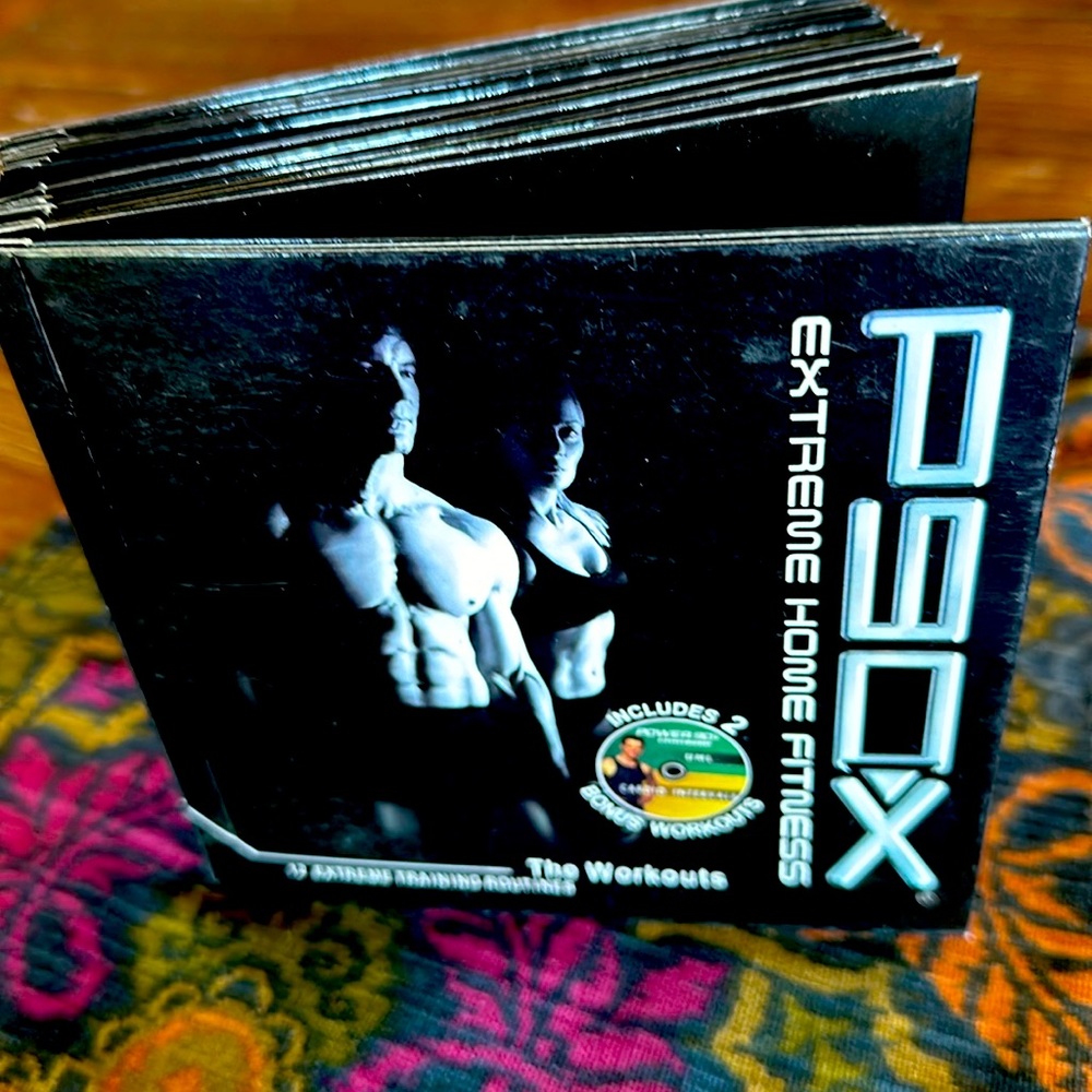 P90X Extreme Training 12 DVD set, most still in plastic wrapping